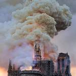Flames and smoke rise as the spire on Notre Dame cathedral collapses in Paris on Monday. Massive plumes of yellow brown smoke filled the air above Notre Dame Cathedral. (AP Photo/Diana Ayanna)
