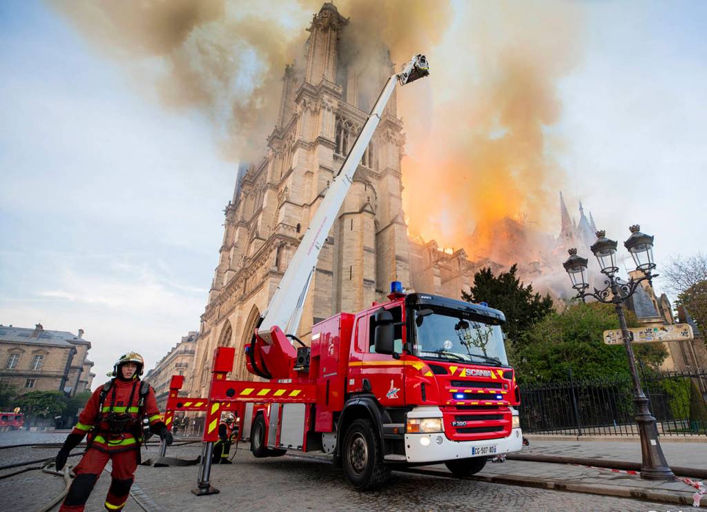 Fire fighters work at the burning Notre Dame cathedral on Monday. Experts assessed the blackened shell of Paris iconic Notre Dame Tuesday morning to establish next steps to save what remains after a devastating fire destroyed much of the cathedral that had survived almost 900 years of history. (Benoit Moser, BSPP via AP)