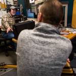Frettin Fingers host Jim Hilmar talks with bass player Brendan Wires during his show at the KSER-FM studio. (Olivia Vanni / The Herald)