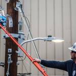Jake Morgan shows how a mylar balloon can cause a transformer to break during the trailer demonstration Wednesday in Everett. (Olivia Vanni / The Herald)