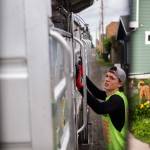 Jeremy Youngren raises the walls of his truck as the sections begin to fill up during his route on Wednesday, April 24, 2019 in Everett, Wash. (Olivia Vanni / The Herald)