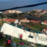 In this image from video, emergency services attend the scene after a tour bus crashed at Canico, on Portugals Madeira Island, on Wednesday . (TVI via AP)