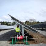 A&R Solar employee Diallo Josey puts the finishing touches on a row of solar panels Monday, April 15. (Julia-Grace Sanders/ The Herald)