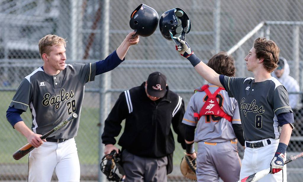 Arlingtons Owen Bishop (left) and Cole Cramer celebrate after Bishop scored during a game against Marysville Pilchuck on April 17, 2019, at Arlington High School. (Kevin Clark / The Herald)