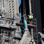 A worker prepares to remove a statue from the damaged Notre Dame cathedral in Paris on Friday. (AP Photo/Thibault Camus)