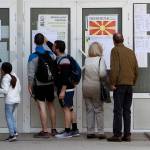 People check lists before voting in the presidential election Sunday outside a polling station in Skopje, North Macedonia. Polls were opened early Sunday in North Macedonia for presidential elections seen as key test of the government following deep polarization after the country changed its name to end a decades-old dispute with neighboring Greece over the use of the term Macedonia. (AP Photo/Boris Grdanoski)