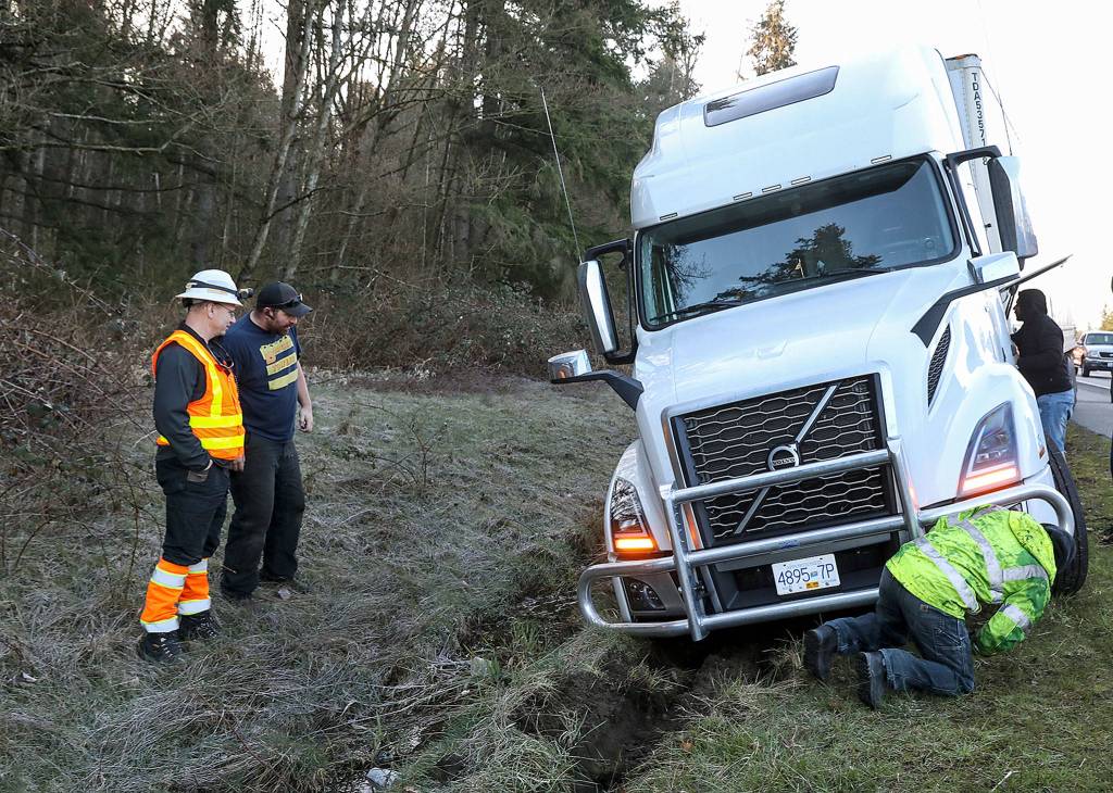 Traffic came to a stop and they probably had to ditch it to not hit someone, Ken Buretta surmised about a scene with a semitruck stuck in a ditch. (Lizz Giordano / The Herald)