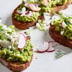 Top sweet pea toasts with sliced radishes and scallions, dill fronds and crumbled feta. (Photo by Stacy Zarin Goldberg for The Washington Post)