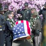 Beth Nakamura / The Oregonian                                An honor guard carries the casket of Cowlitz County Deputy Justin DeRosier as a procession makes its way to the Chiles Center at the University of Portland, where a memorial service took place Wednesday for the slain deputy in Portland, Oregon.
