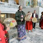 Earth Feather Sovereign (left), of the Confederated Tribes of the Colville Reservation, joins others in playing drums and singing in the Capitol Rotunda in Olympia on Wednesday after Gov. Jay Inslee signed a bill into law. The bill creates liaison positions within the Washington State Patrol, and requires the agency to develop best practices in hopes of reducing disproportionate rates of violence faced by Native American and indigenous women, and also the frequency with which perpetrators of the crimes avoid justice. (AP Photo/Ted S. Warren)