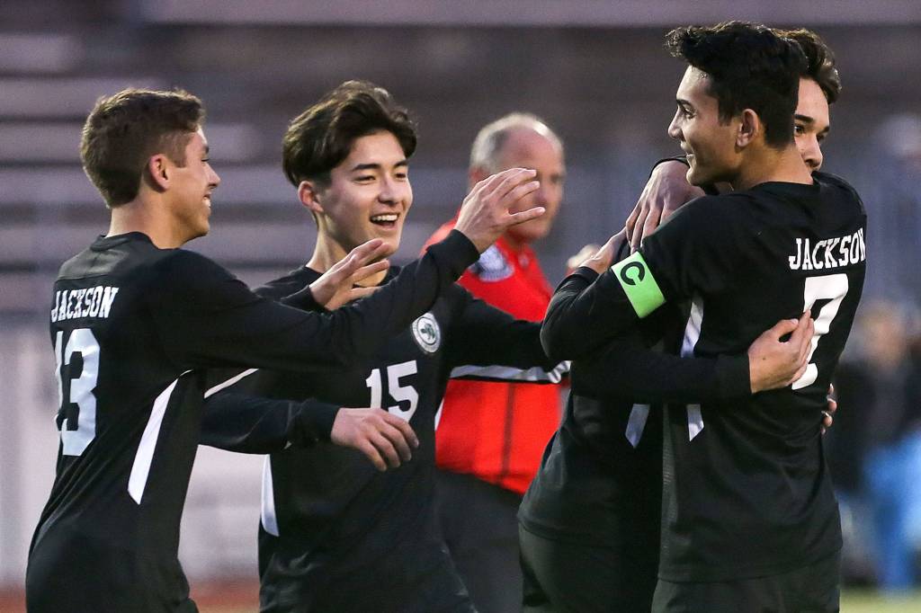 Jacksons Adan Fernandez (left-right) Kota Mccann, Oliver Giessler and Kevin Giessler celebrate a goal against Cascade Friday night at Everett Memorial Stadium in Everett on April 26, 2019. (Kevin Clark / The Herald)