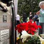 Dozens of people gathered Thursday night to remember Jae An, 58, a mini mark clerk killed in a robbery on Broadway in Everett. (Caleb Hutton / The Herald)