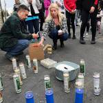 Dozens of people gathered Thursday night to remember Jae An, 58, a mini mark clerk killed in a robbery on Broadway in Everett. (Caleb Hutton / The Herald)