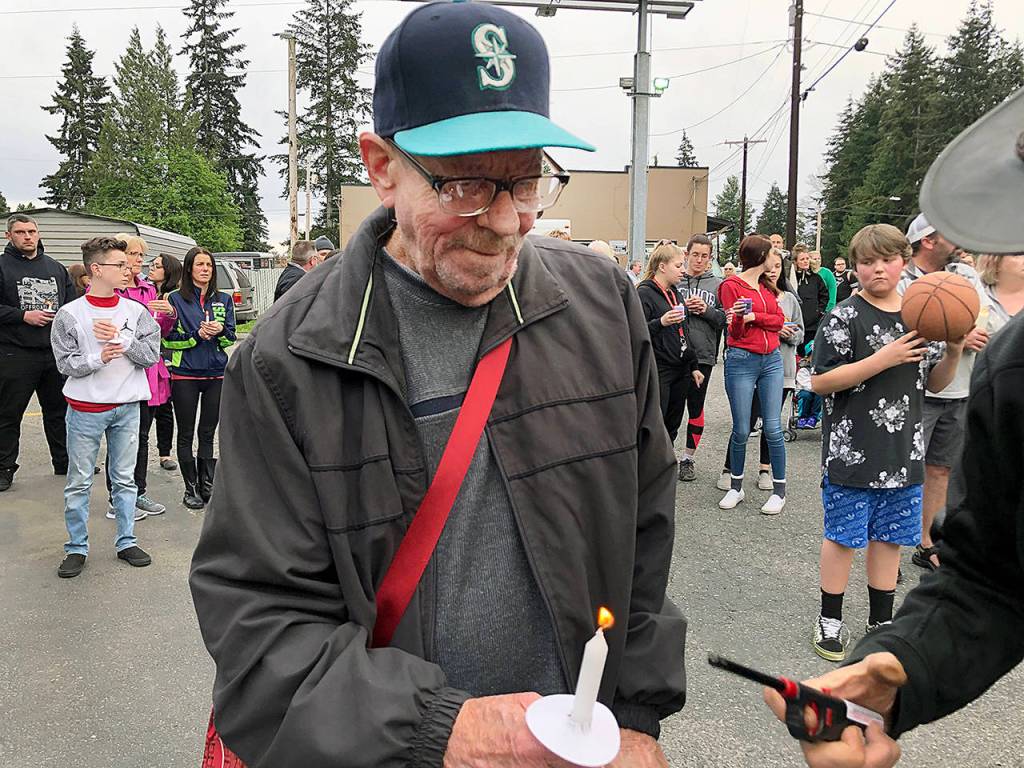 Dozens of people gathered Thursday night to remember Jae An, 58, a mini mark clerk killed in a robbery on Broadway in Everett. (Caleb Hutton / The Herald)