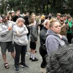 Dozens of people gathered Thursday night to remember Jae An, 58, a mini mark clerk killed in a robbery on Broadway in Everett. (Caleb Hutton / The Herald)