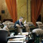 Republican Rep. Matt Shea sits at his desk on the House floor on Friday in Olympia. Shea has been dogged this week by the release of text messages from 2017 in which he appeared to condone surveillance and even violence against political enemies. (AP Photo/Rachel La Corte)