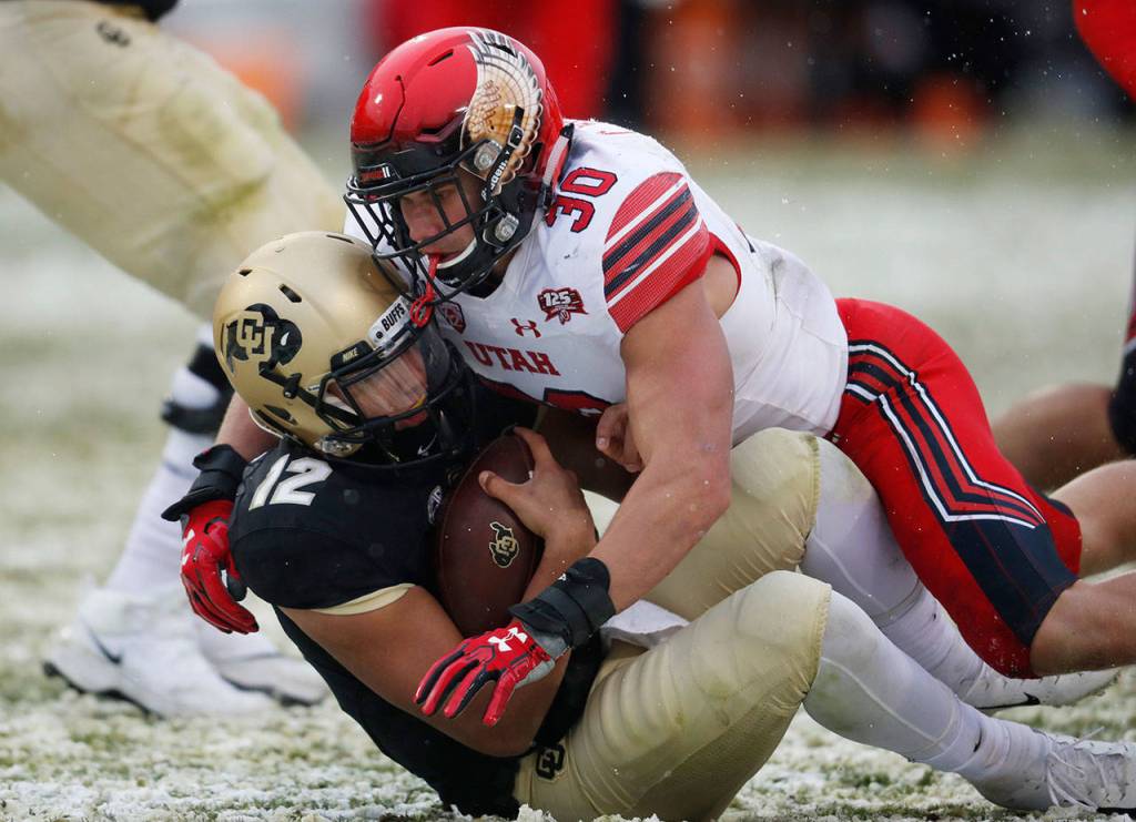 Utah linebacker Cody Barton (top) tackles Colorado quarterback Steven Montez during a game on Nov. 17, 2018, in Boulder, Colo. (AP Photo/David Zalubowski)