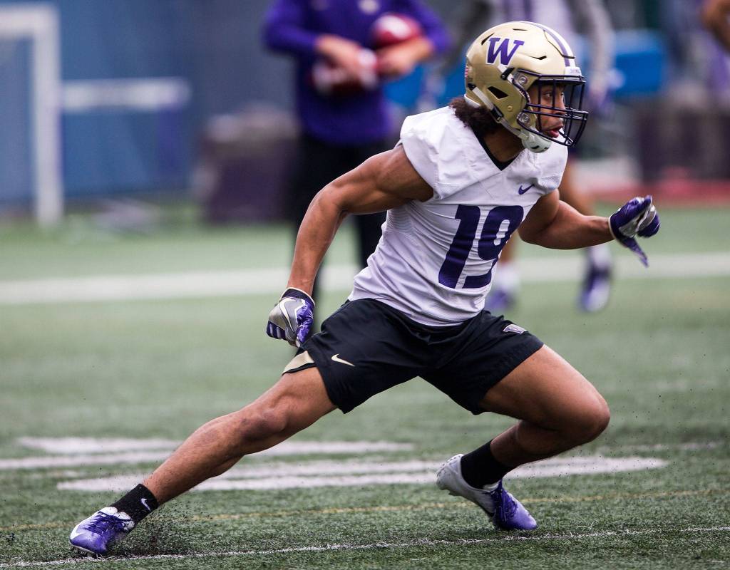 Washington defensive back Kyler Gorson (19), runs through position drills during spring practice on April 3 in Seattle. (Olivia Vanni / The Herald)