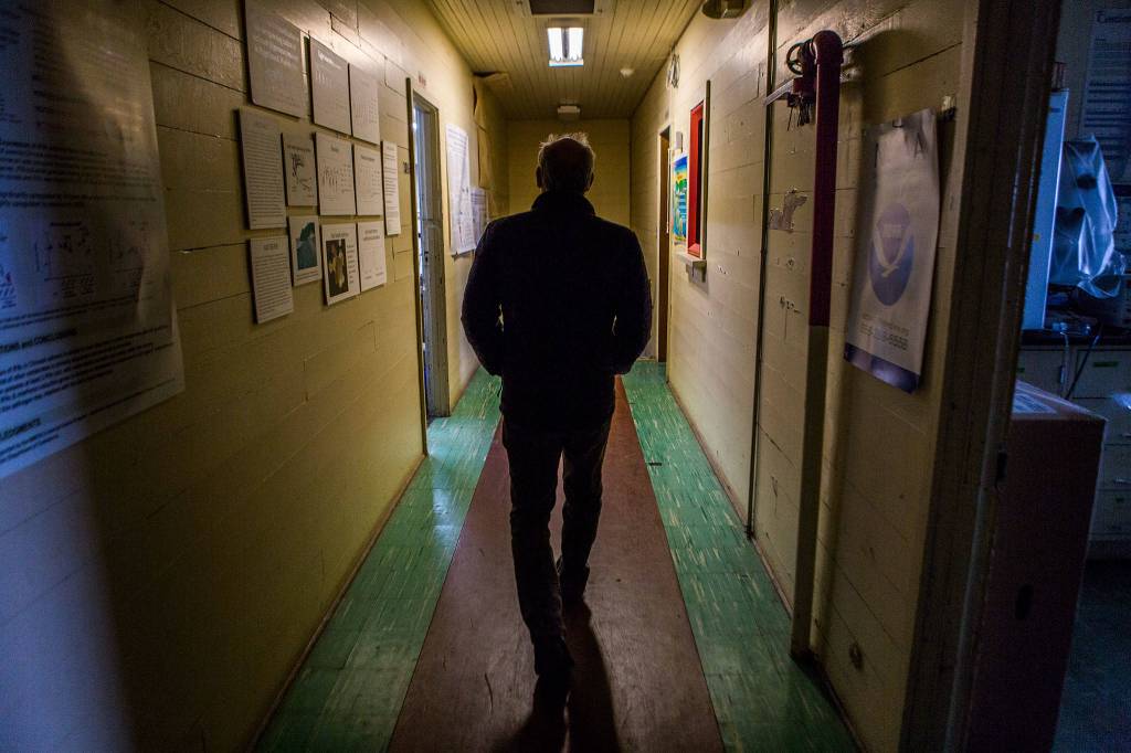 Paul McElhany, Mukilteo Station chief, walks down the second floor hallway at Northwest Fisheries Science Centers Mukilteo Research Station on April 23 in Mukilteo. (Olivia Vanni / The Herald)