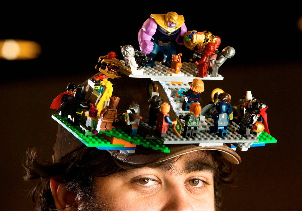 Bryan Hinze, of Lynnwood, sports a Avengers Lego themed hat, with a couple DC super heroes mixed in, while attending the first showing of Avengers: Endgame at the AMC Alderwood Mall 16 on April 25 in Lynnwood. (Andy Bronson / The Herald)