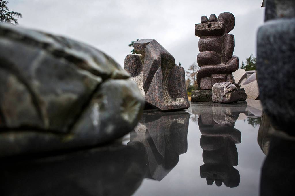 A sculpture is reflected off of a smooth surface at the Cloudstone Sculpture outdoor gallery in Freeland. (Olivia Vanni / The Herald)