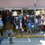 Customers, with passports in hand, line up for a stamp outside Edmonds Bookshop. (Kevin Clark / The Herald)