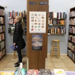 Lauren Hope browses the shelves of Neverending Bookstore in Edmonds. People who visited 21 stores earned a 25-percent discount for the entire year. (Kevin Clark / The Herald)