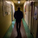 Paul McElhany, station chief, walks down the uneven second floor hallway at Northwest Fisheries Science Centers Mukilteo Research Station. (Olivia Vanni / The Herald)