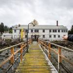 Paul McElhany points out how the new building will be different from the old Air Force structure housing Mukilteo Research Station. (Olivia Vanni / The Herald)