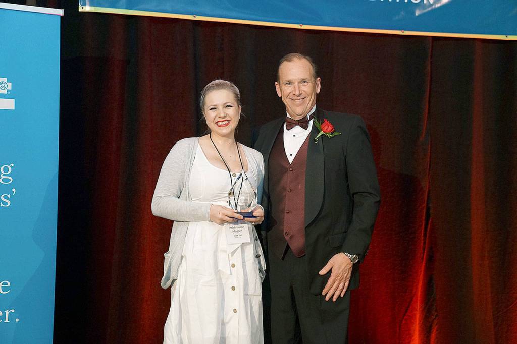 Kristina Ann Madden, a 2012 Edmonds Community College graduate, received the 2019 Distinguished Alumni award from Foundation Executive Director Brad Thomas. (Edmonds Community College)