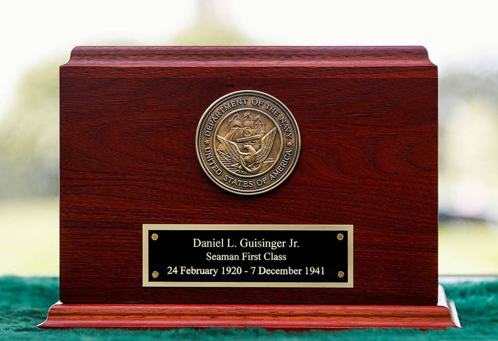 A Navy medallion is part of a cherry wood urn holding the ashes of Daniel Guisinger Jr. (Dan Bates / The Herald)