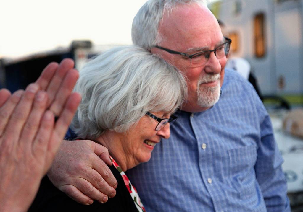 Dan Hoeglund hugs his aunt, Judy Price, during a plane-side ceremony at Sea-Tac Airport. Prices mother was the sister of Daniel Guisinger, whose remains were returned to Washington after being identified using Prices DNA. Guisinger was an Everett sailor killed at Pearl Harbor. (Dan Bates / The Herald)