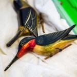 A wooden hummingbird that was made in an internment camp is displayed during Judy Kusakabes talk at Kamiak High School. (Olivia Vanni / The Herald)
