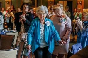 As Mary Elaine Burgess, an Assistance League volunteer for 50 years, walks to receive the groups Circle of Honor Award, Thursday, everyone in the Everett Golf and Country Club stands and applauds. (Dan Bates / The Herald)
