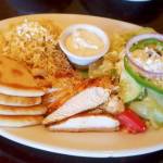 A plate of broiled marinated chicken, rice and pasta pilaf, Greek salad, tzatziki and pita at Kafe Neo. (Sharon Salyer / The Herald)