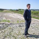 Erik Gerking, the Port of Everetts director of environmental programs, walks along the separation dike on the east side of I-5 on Monday. The port, working with a private company, has been stockpiling clean fill dirt for an upcoming habitat project in the Snohomish River estuary. (Andy Bronson / The Herald)