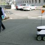 State Rep. Steve Tharinger, D-Sequim, walks by a delivery robot during a demonstration outside the Washington Capitol in Olympia on Jan. 28. (AP Photo/Rachel La Corte)