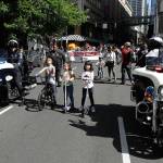 Seattle police officers on motorcycles are joined by younger members of the community as they move ahead of a march for immigrant and workers rights Wednesday on May Day in downtown Seattle. (AP Photo/Ted S. Warren)