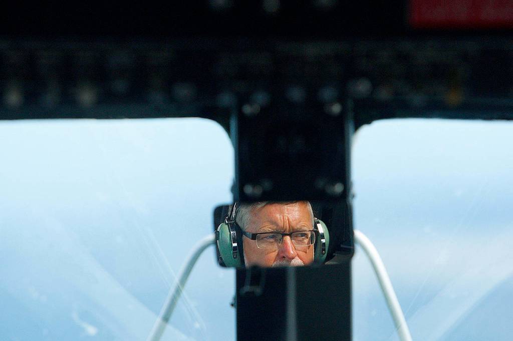 John Sessions flies a DC-3 over the Puget Sound in August 2013. (Mark Mulligan / Herald file)