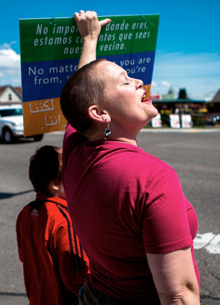 Liz Vogeli, an Everett City Council member, helps start a chant during the monthly march in solidarity with immigrants and refugees on Sunday in Everett. (Olivia Vanni / The Herald)