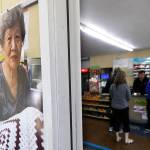 A photo of slain store-owner Soon Ja Nam, 79, hangs next to the doorway of the Handy Corner Food Store on Tuesday in Puyallup. Expressions of support and mourning from the community have continued since Nam was shot and killed Saturday during a robbery. (AP Photo/Ted S. Warren)
