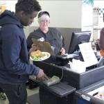 A student buys lunch in the cafeteria at Burlington High School in Burlingtonon, Vermont, on April 5.. The schools food service provider is preparing to comply with a Trump administration decision to roll back a rule that required only whole-grain rich foods for school meals. Burlington officials said they dont plan on abandoning whole-grain foods, but it gives them flexibility. (AP Photo/Wilson Ring)