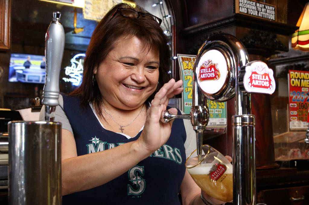 Bartender Denise McKenzie pours a beer at Kuhnles Tavern in Marysville on May 1. (Kevin Clark / The Herald)