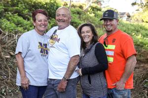 Marie Grady (left to right), Johnny Wickerling, Kimberly Kelley and Jason Kelley, helped clean up a neighborhood playground in the South Forest Park area. (Lizz Giordano / The Herald)