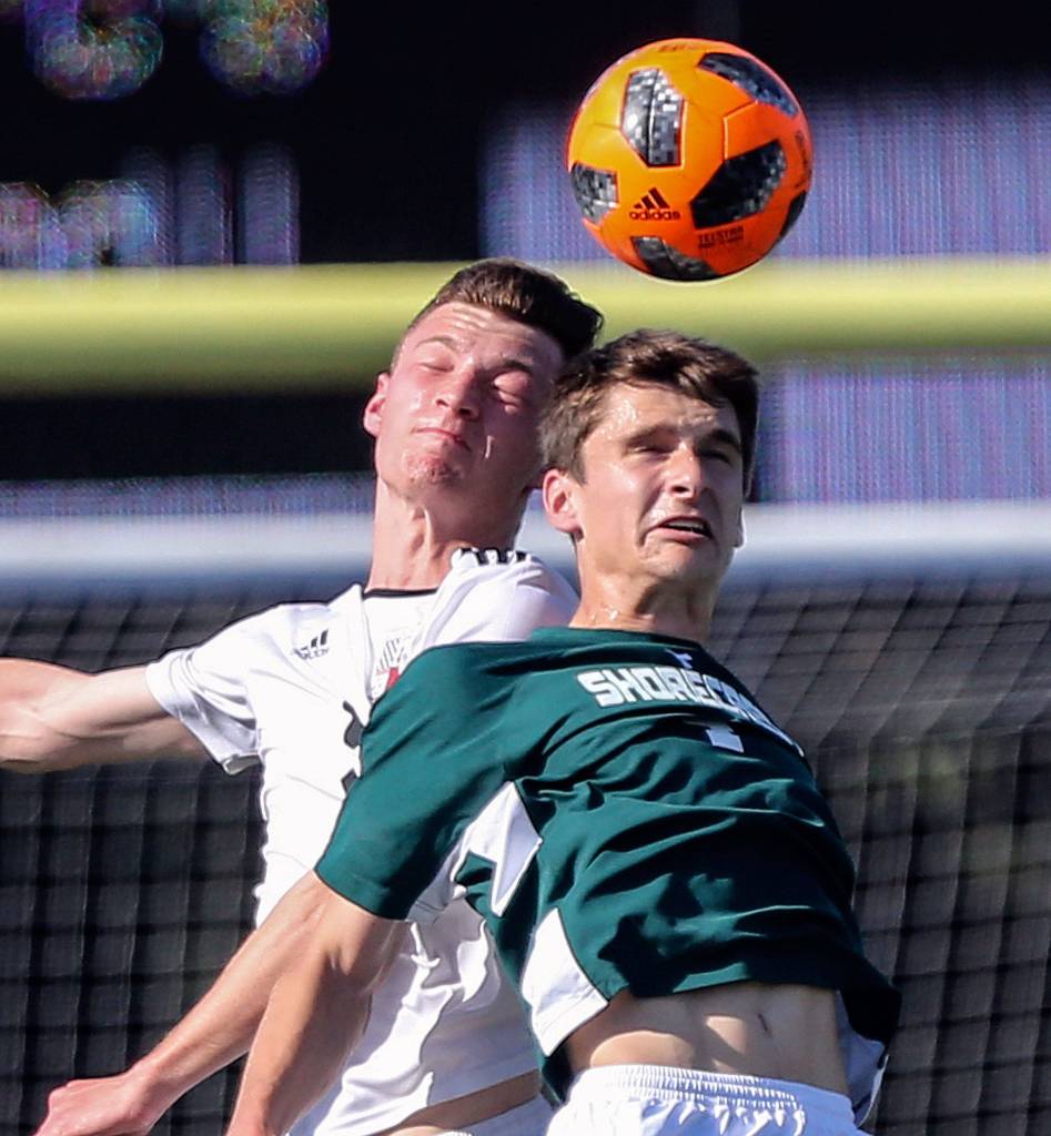 Snohomishs Liam Raney (left) and Shorecrests Noah Trostle jump for a header during a 3A district winner-to-state, loser-out match on May 9, 2019, in Shoreline. (Kevin Clark / The Herald)