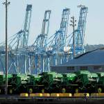 John Deere Agricultural machinery made by Deere & Company sits staged for transport Friday, near cranes at the Port of Tacoma. U.S. and Chinese negotiators resumed trade talks Friday under increasing pressure after President Donald Trump raised tariffs on $200 billion in Chinese goods and Beijing promised to retaliate. (AP Photo/Ted S. Warren)