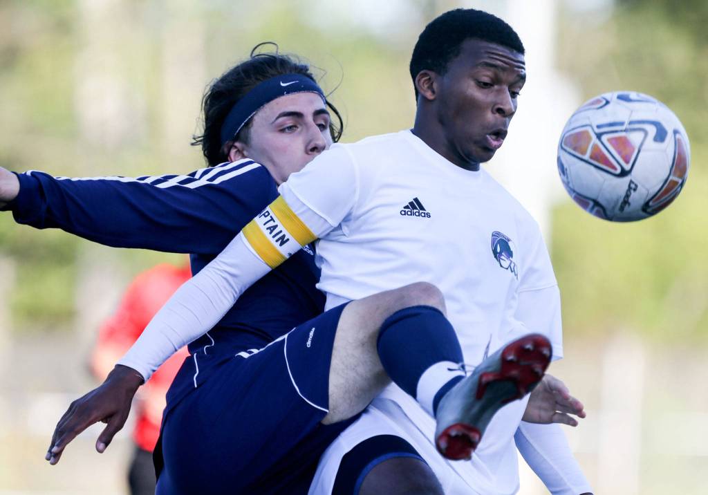 Meadowdales Jacob Sessler (left) works to get around Edmonds-Woodways Ben Forder during the NW District 1 3A Soccer Tournament at Shoreline Stadium on May 7. The Mavericks won 1-1 with free kicks. (Kevin Clark / The Herald)