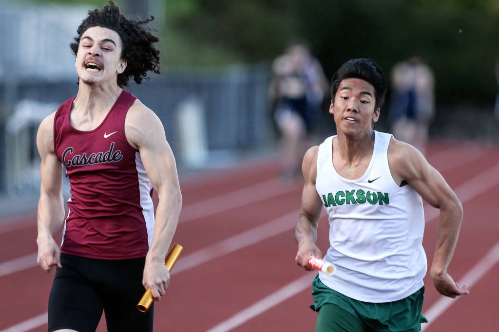 Cascades Michael Purl (left) edges out Jacksons Koji Asuncion in the 4x100 meter relay during the Everett City Championships at Everett Memorial Stadium on May 3. (Kevin Clark / The Herald)
