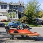 Peter Olesen (seated), Jim Tryon and Steve Olesen work to build Peters hydroplane Wednesday afternoon in Mill Creek. (Kevin Clark / The Herald)