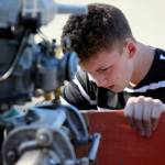 Peter Olesen mounts screws on his custom-built hydroplane Wednesday afternoon in Mill Creek. (Kevin Clark / The Herald)